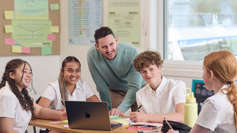 Teacher with group of secondary school students