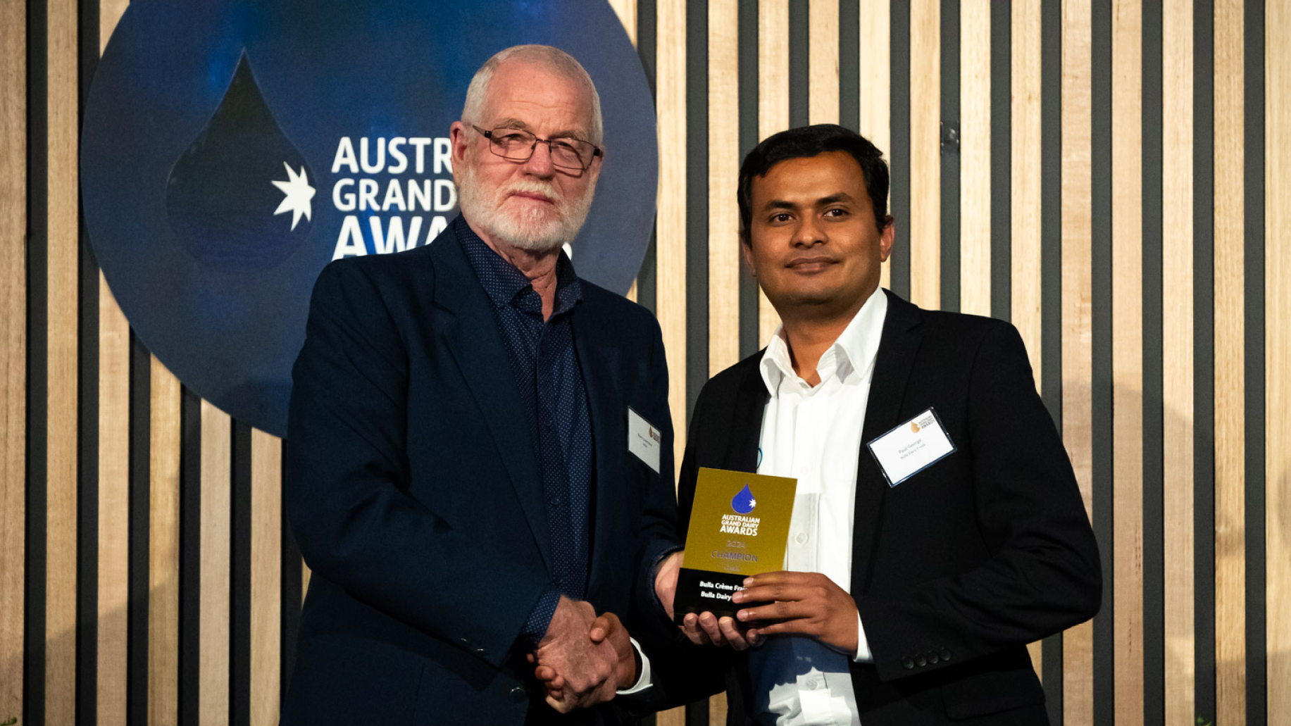 An AGDA judge is presenting an award to a category winner.